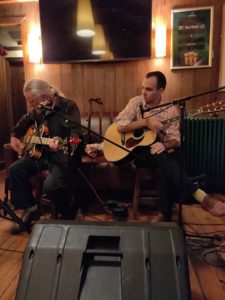 Two Men playing guitar in pub 