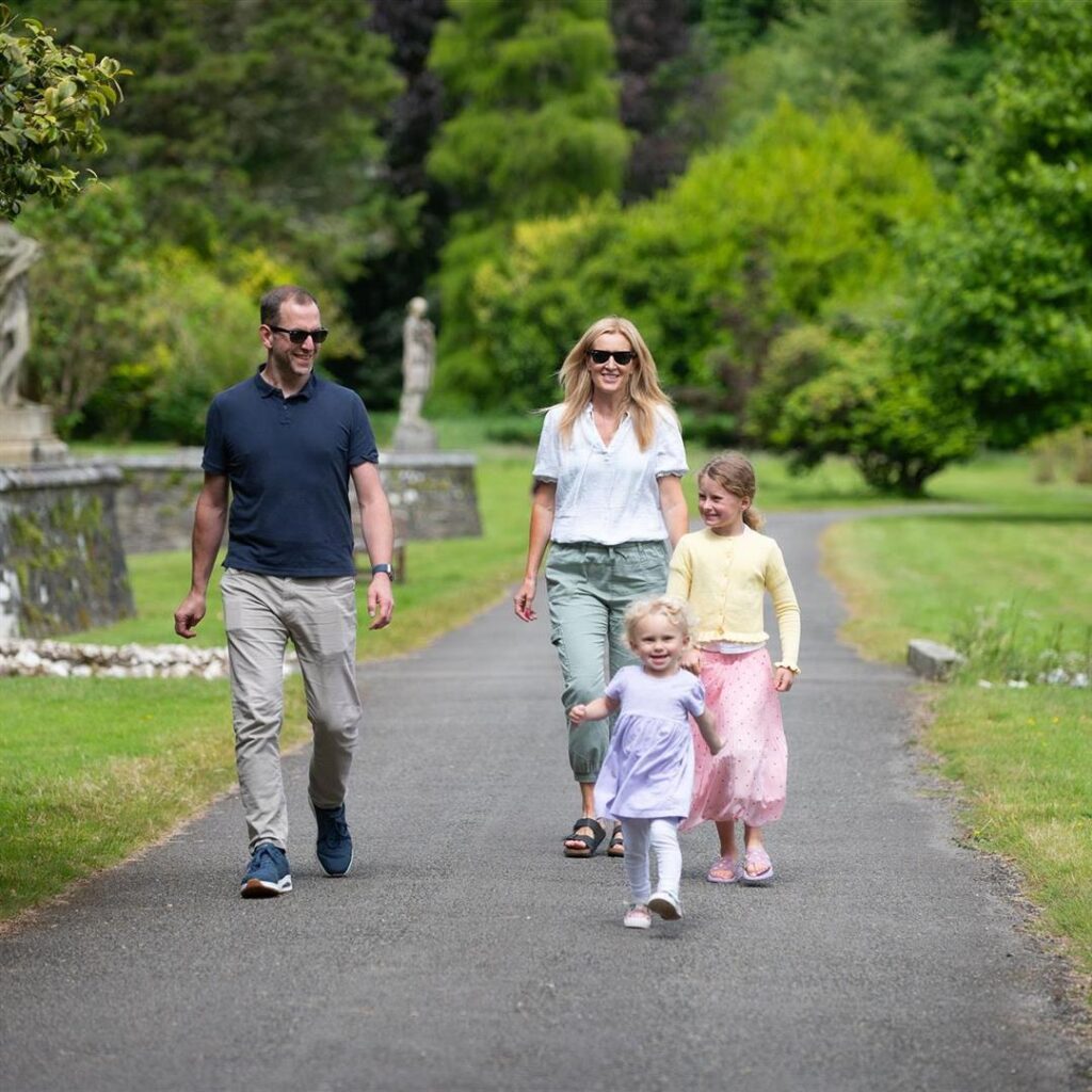 two young children walking with parents in Johnstown Castle Gardens